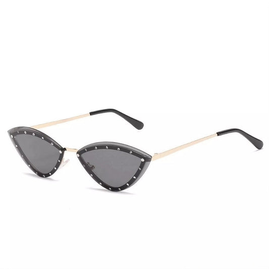 Trendy cat-eye sunglasses with narrow black frame, sparkling accents, and UV-protective dark lenses.