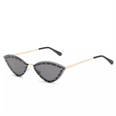 Trendy cat-eye sunglasses with narrow black frame, sparkling accents, and UV-protective dark lenses.